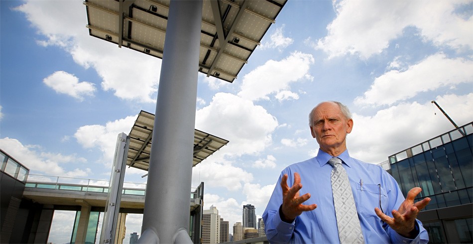 Professor Ian MacKinnon with 'solar trees' on QUT's Science and Engineering Centre