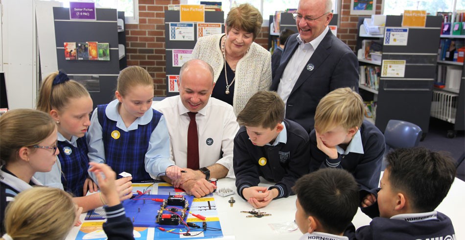Photo of a previous Electricity Safety Week with former Ausgrid CEO Richard Gross and former energy minister Matt Kean interacting with school children