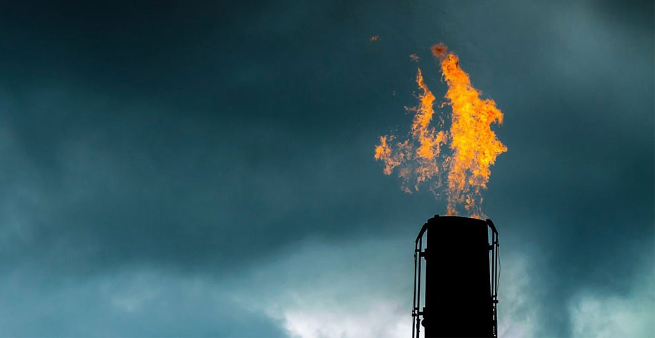Gas flame from industrial chimney against cloudy sky (gas deals)