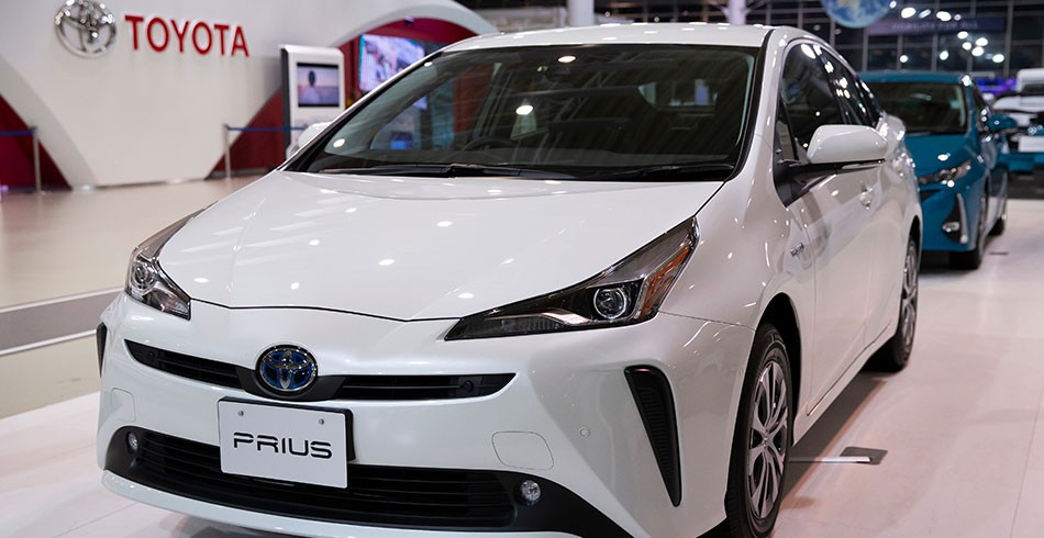 White Toyota Prius photographed in a showroom