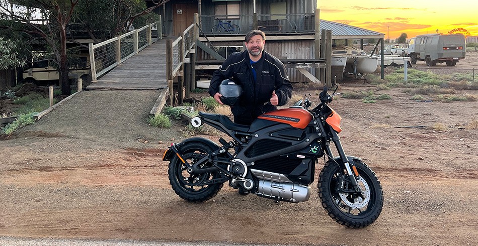 Duncan Mallord with his electric motorcycle outside Lake Eyre Yacht Club