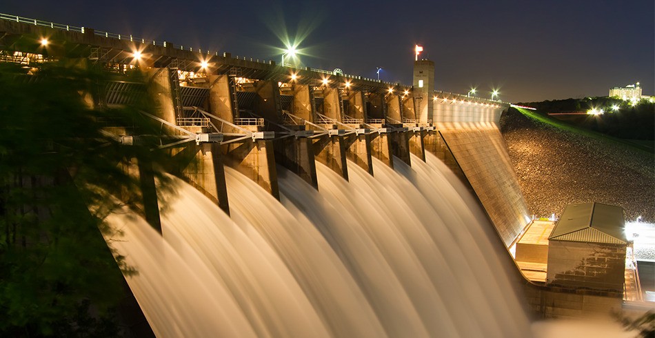 Water rushes through hydroelectric dam at night (pumped hydro EDF)
