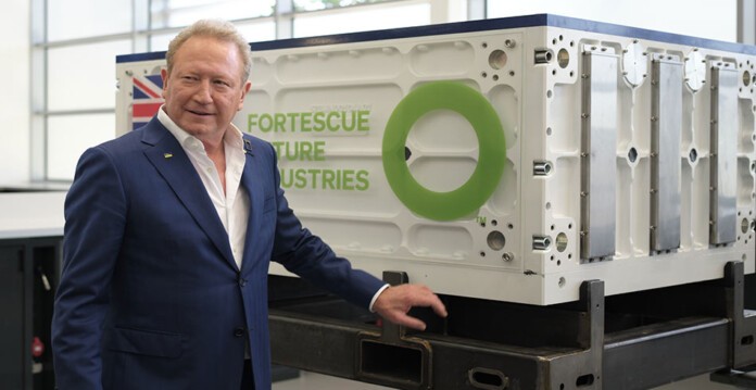 Fortescue chairman Dr Andrew Forrest standing in front of Fortescue-branded battery (projects)