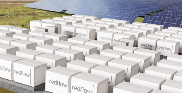Concept image of Redflow batteries with solar panels in background (california)