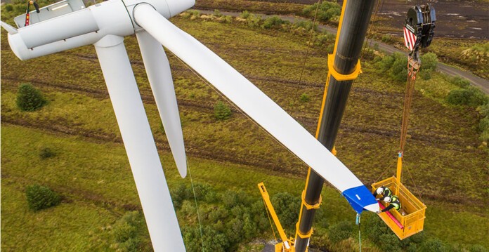 Rigger works on wind turbine blade suspended from crane basket (Ingeteam RES)
