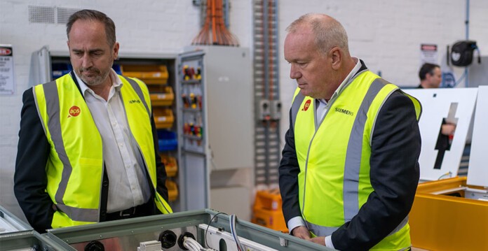 David Hegarty, Managing Director, APS Industrial and Peter Halliday, CEO, Siemens Australia wearing high-vis vests and exploring the new manufacturing facility