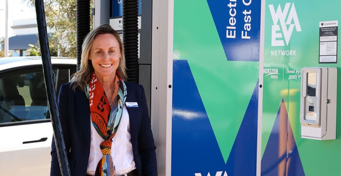 Horizon Power's female CEO stands next to new EV fast charger with WA EV Network branding
