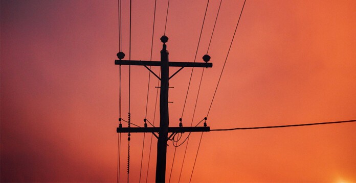 Powerlines set against hazy orange sky (faults)