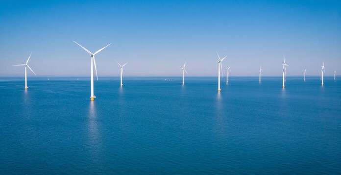 Large offshore wind turbines in beautiful blue ocean with blue sky (dogger bank)
