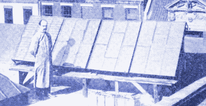 Early black and white image of inventor George H Cover with his third iteration of a solar panel