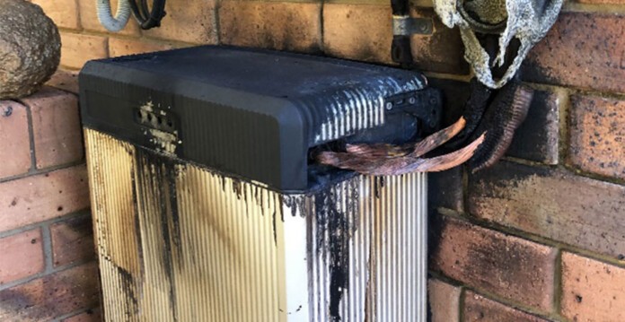Burnt solar storage system installed against brick wall of home (LG recall)