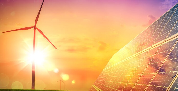 Wind turbine with solar panels against beautiful sunny orange sky (renewable locally)