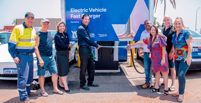 Smiling people and officials at ribbon cutting ceremony of EV fast charger in Karratha (WA)