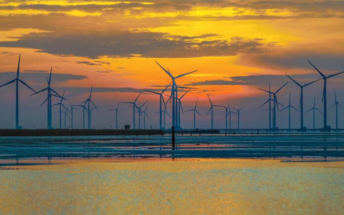 Offshore wind turbines with beautiful sunset in the background
